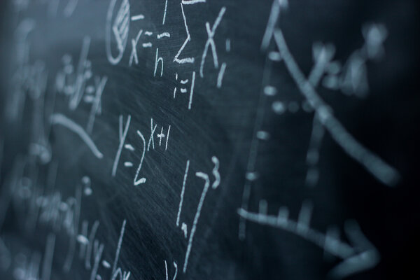 Maths formulas on chalkboard background